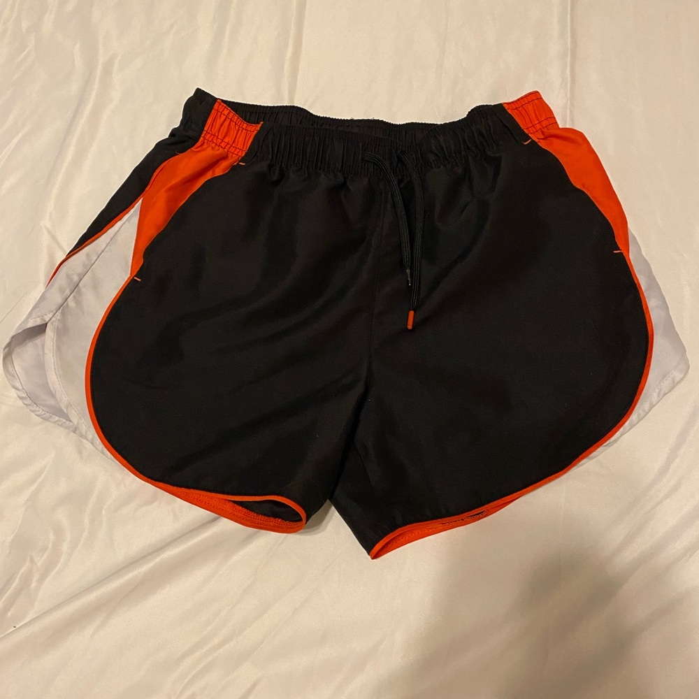 black and orange fairly worn bcg active shorts size M